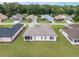 An aerial view of the back of the home shows an enclosed lanai and large, manicured lawn at 6858 Sw 111Th Loop, Ocala, FL 34476