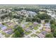 An aerial view showcasing the community's layout, clubhouse, and proximity to a lake at 6858 Sw 111Th Loop, Ocala, FL 34476