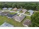 Aerial view of homes with mature trees, lush greenery, and well-manicured lawns at 6858 Sw 111Th Loop, Ocala, FL 34476