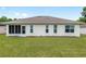 Well-kept backyard featuring a screened-in porch and a view of neighboring properties at 6858 Sw 111Th Loop, Ocala, FL 34476