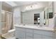 Bright bathroom with dual sinks, large mirror, shower, and toilet at 6858 Sw 111Th Loop, Ocala, FL 34476