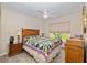 Comfortable bedroom with hardwood floors, and a quaint decorative sailboat at 6858 Sw 111Th Loop, Ocala, FL 34476