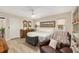 Inviting bedroom with soft lighting, hardwood floors, and comfortable seating at 6858 Sw 111Th Loop, Ocala, FL 34476