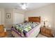 Comfortable bedroom featuring hardwood floors, a ceiling fan, and closet at 6858 Sw 111Th Loop, Ocala, FL 34476