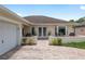 Well-maintained single-story home featuring an attached garage, landscaped front yard, and curved brick driveway at 6858 Sw 111Th Loop, Ocala, FL 34476