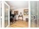 Elegant foyer with glass paneled entry door, hardwood floors, and sophisticated piano at 6858 Sw 111Th Loop, Ocala, FL 34476