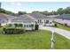 Beautiful single-Gathering home featuring lush green lawn, brick-paved driveway, and welcoming front patio area at 6858 Sw 111Th Loop, Ocala, FL 34476