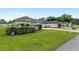 Well-maintained front yard with lush lawn, mature landscaping, and a paved driveway at 6858 Sw 111Th Loop, Ocala, FL 34476