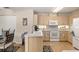 Kitchen features bright cabinets, white appliances, and tiled flooring at 6858 Sw 111Th Loop, Ocala, FL 34476