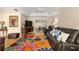 Relaxing living room boasts hardwood floors, leather sofa, and view to the piano room at 6858 Sw 111Th Loop, Ocala, FL 34476