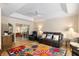 Comfortable living room with tray ceilings, fan, leather sofa, and colorful floral area rug at 6858 Sw 111Th Loop, Ocala, FL 34476