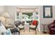 Cozy sitting area features bay window overlooking front yard, wicker chairs, and a table at 6858 Sw 111Th Loop, Ocala, FL 34476