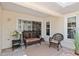 Outdoor patio with brick flooring and features a wicker bench with cushions, perfect for outdoor relaxation at 6858 Sw 111Th Loop, Ocala, FL 34476