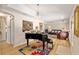 Open floor plan featuring living room and piano room with hardwood floors and tray ceilings at 6858 Sw 111Th Loop, Ocala, FL 34476