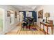 Elegant piano room features tray ceilings, beautiful art, and gleaming hardwood floors at 6858 Sw 111Th Loop, Ocala, FL 34476