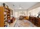 Spacious sun room with bookshelves and natural lighting perfect for relaxing or entertaining guests at 6858 Sw 111Th Loop, Ocala, FL 34476