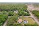 Wide aerial view of a home with a pool and multiple outbuildings, situated on a large lot near roads at 8130 Sw 209Th Court Rd, Dunnellon, FL 34431