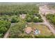 Wide aerial view of a home with a pool and multiple outbuildings, surrounded by trees and roads at 8130 Sw 209Th Court Rd, Dunnellon, FL 34431