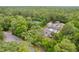 An aerial perspective of the home on a heavily treed lot with a screened in pool at 8130 Sw 209Th Court Rd, Dunnellon, FL 34431
