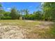 Spacious backyard with a metal storage shed surrounded by a mix of grass and sandy areas at 8130 Sw 209Th Court Rd, Dunnellon, FL 34431