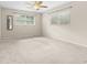 Spacious bedroom with neutral carpet, ceiling fan, and two large windows at 8130 Sw 209Th Court Rd, Dunnellon, FL 34431