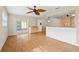 Open concept living space and kitchen with wood floors and sliding glass doors to the lanai at 8130 Sw 209Th Court Rd, Dunnellon, FL 34431