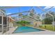The screened-in pool has a ladder and overlooks the property at 8130 Sw 209Th Court Rd, Dunnellon, FL 34431