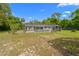 An enclosed screened in pool located at the rear of the house is surrounded by tall trees at 8130 Sw 209Th Court Rd, Dunnellon, FL 34431