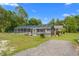 A screened-in pool with a lush backyard and ample outdoor space at 8130 Sw 209Th Court Rd, Dunnellon, FL 34431