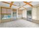 This sunroom features tile floors, natural window coverings and views of the pool at 8130 Sw 209Th Court Rd, Dunnellon, FL 34431