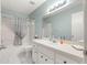 Well-lit bathroom with a shower-tub combo and vanity with blue-green walls at 8569 Sw 92Nd Ln # D, Ocala, FL 34481