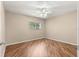 Comfortable bedroom featuring hardwood floors, a large window, and neutral paint at 8569 Sw 92Nd Ln # D, Ocala, FL 34481