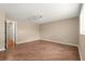Spacious bedroom features wood-look flooring and a door with a view to a hallway at 8569 Sw 92Nd Ln # D, Ocala, FL 34481