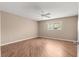 Bedroom features wood-look flooring, a ceiling fan, and natural light from the window at 8569 Sw 92Nd Ln # D, Ocala, FL 34481
