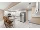 Spacious kitchen with white cabinets, stainless steel appliances, and a breakfast bar at 8569 Sw 92Nd Ln # D, Ocala, FL 34481