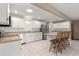 Spacious kitchen featuring white cabinets, stainless steel appliances, and breakfast bar at 8569 Sw 92Nd Ln # D, Ocala, FL 34481
