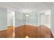 Open-concept living room with wooden flooring, a light fixture, and light gray walls at 8569 Sw 92Nd Ln # D, Ocala, FL 34481