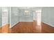 Spacious living room featuring hardwood floors, neutral paint, and elegant lighting at 8569 Sw 92Nd Ln # D, Ocala, FL 34481