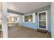 Inviting covered porch with white railings and brick accents, leading to the front door at 8569 Sw 92Nd Ln # D, Ocala, FL 34481