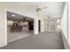Sunroom with neutral carpet, views to the kitchen, and backyard access at 8569 Sw 92Nd Ln # D, Ocala, FL 34481