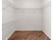 Spacious walk-in closet with white wire shelving and wood-look flooring at 8569 Sw 92Nd Ln # D, Ocala, FL 34481