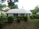 Landscaped backyard with lush greenery, flowers, and a serene outdoor setting at 8765 Sw 190Th Cir, Dunnellon, FL 34432