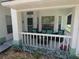 Cozy front porch featuring stylish outdoor seating and plants at 8765 Sw 190Th Cir, Dunnellon, FL 34432