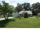 Well-maintained front yard featuring a fountain and manicured lawn at 8765 Sw 190Th Cir, Dunnellon, FL 34432