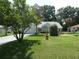 Landscaped front yard with a fountain and lush green lawn at 8765 Sw 190Th Cir, Dunnellon, FL 34432