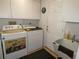 Well-lit laundry room equipped with washer, dryer, utility sink, and ample storage space at 8765 Sw 190Th Cir, Dunnellon, FL 34432
