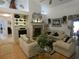 Spacious living room featuring a fireplace, high ceilings, and stylish decor at 8765 Sw 190Th Cir, Dunnellon, FL 34432