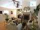 Bright living room with vaulted ceilings, a fireplace, and comfortable furnishings at 8765 Sw 190Th Cir, Dunnellon, FL 34432