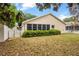 Well-manicured backyard featuring a lush green lawn and a cozy screened patio for outdoor enjoyment at 9093 Sw 91St Cir, Ocala, FL 34481
