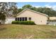 Spacious backyard featuring a well-kept lawn, mature trees, and a screened patio perfect for relaxation at 9093 Sw 91St Cir, Ocala, FL 34481